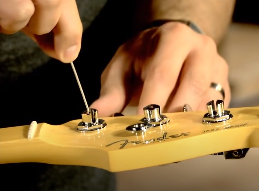Insert in Tuning Peg and use a Guitar Winder