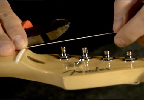 attach the string in the turning pegs