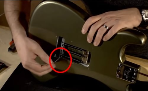 insert new string at the back of the electric guitar
