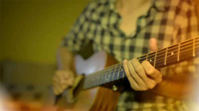 adult-playing-a-guitar